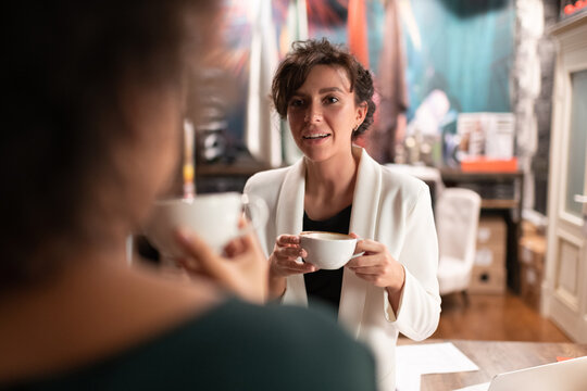 Female boss speaking with colleague during break