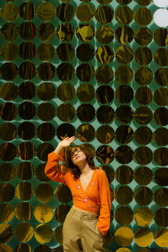 Woman standing on the backgroiund of shimmering wall 