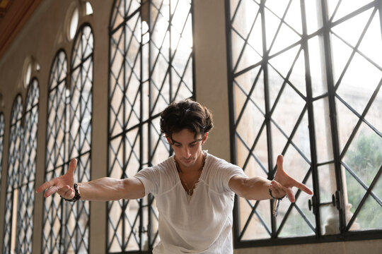 Male dancer stretching arms towards camera