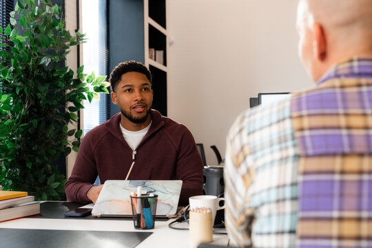 Men talking at office 