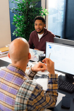Discussion Between Two Men in an Office Setting During the Day
