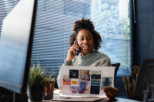 Woman talking via phone at work 