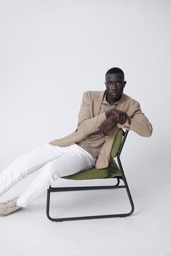 A man seated thoughtfully on chair