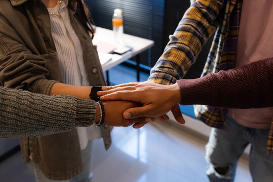 Team members stack hands in unity 