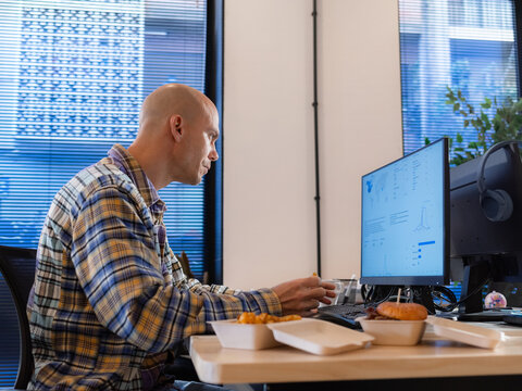 Focused man working on computer at office 