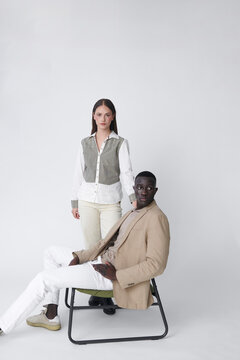 man and woman duo seated thoughtfully on chair