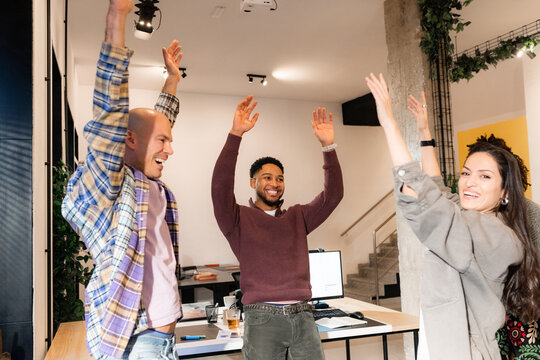 Team Members Celebrate Success in Modern Office Space