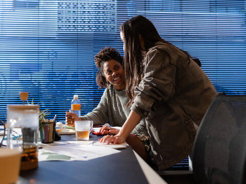 Colleagues discussing work at office 