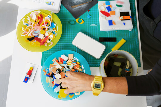 Creative Workspace With Art Materials and Colored Shapes Spread Out