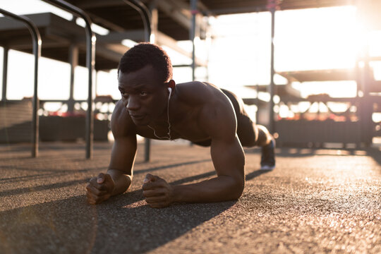 Sportive serious black man doing plank