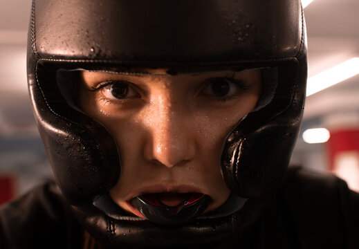 Sweaty female fighter looking at camera