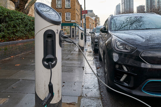 Electric Vehicle Charging Station on a City Street With Parked Car