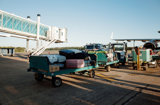Baggage Carts Prepare for Flight at the Airport Terminal