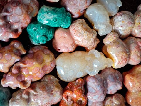 Colorful Carved Stones of Various Shapes Gathered in a Box