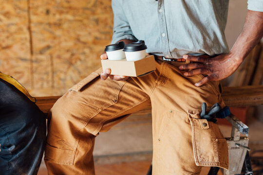 Construction Worker Holding Coffee Cups
