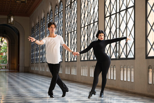 Graceful couple practicing ballroom dance steps