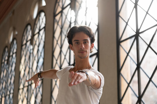 Male dancer spinning around against window