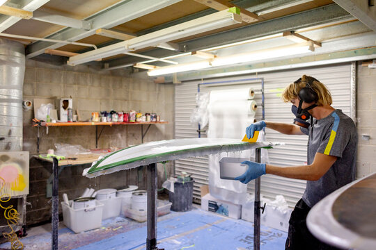 Shaper laminating surfboard in Australia