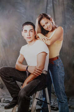 Teenage couple posing in a 1990s studio portrait