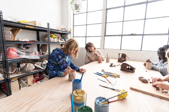 Kids Painting Clay at Studio Table
