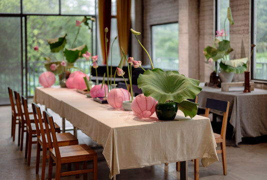Dining table decorated with lotus flowers and leaves