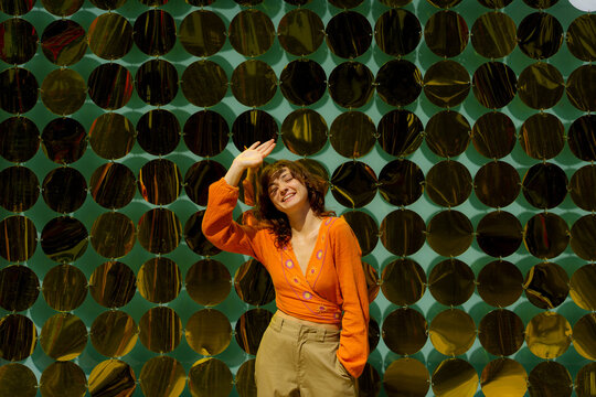 Woman standing on the backgroiund of shimmering wall 