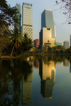 Bangkok cityscape reflecting in the pond of Lumphini park 