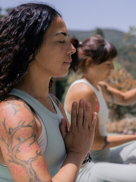 Women Practice Meditation in a Nature Under Bright Sunlight