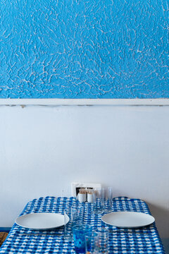 Table set for two with blue checkered cloth