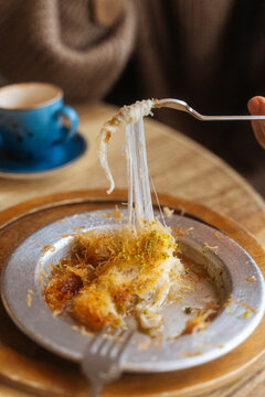Cheese-filled k&Atilde;&frac14;nefe dessert being served with fork