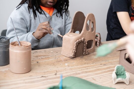 Student Painting Clay House Sculpture