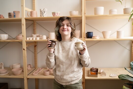 Young Person Holding Handmade Ceramic Cups