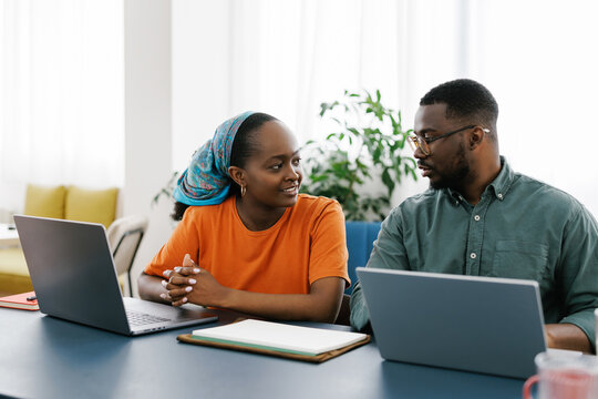 Two Colleagues Discuss Ideas During a Meeting in a Bright Office