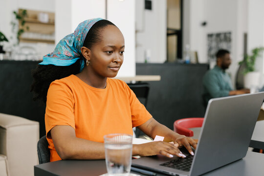 African-American Woman Working on Laptop in a Cafe 