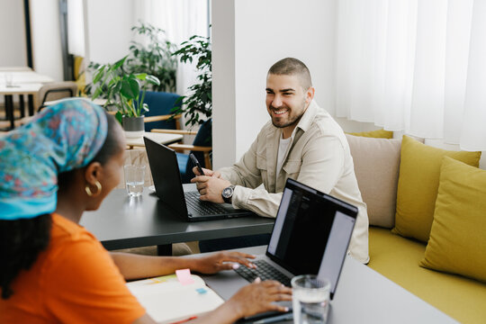 Two People Having a Friendly Conversation in a Modern Workspace 