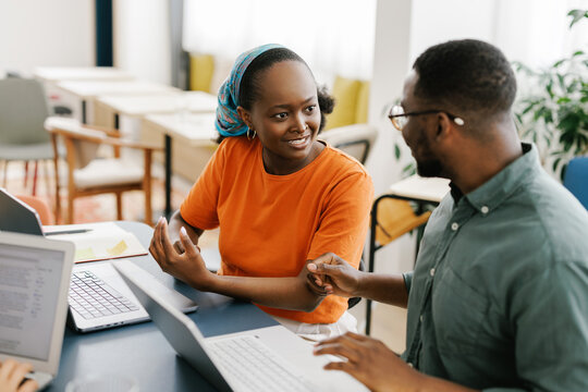 Two People Discuss Ideas During a Meeting in a Bright Office