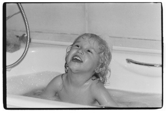 The boy is taking a bubble bath
