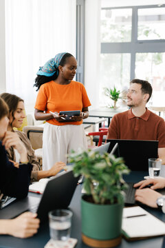Team Member Shares Ideas During a Meeting in a Bright Office Space