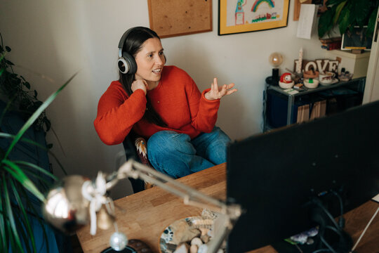 Woman Wearing Headphones Talking During Video Call