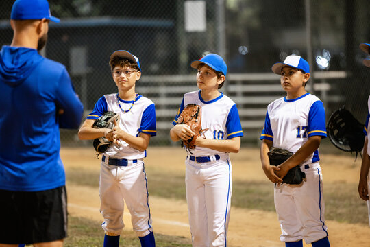 baseball players listens to a coach