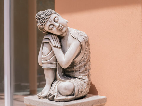 Sleeping Buddha Statue in a Serene Courtyard During Daytime Hours