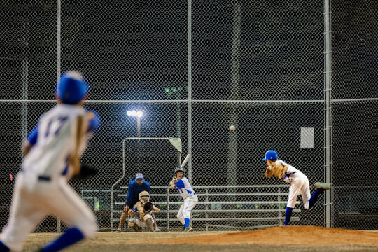 Young Baseball Team Trains Outdoors at Night