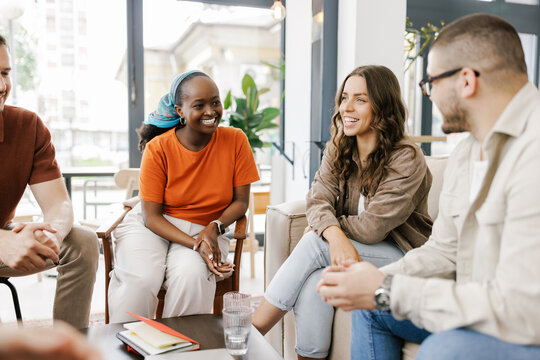 Friends Gather and Talk in Cafe During Afternoon