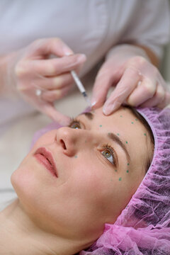 Cosmetic injections in forehead at beauty clinic