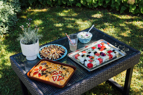 Summertime snacks - focaccia, fruits, nuts and hummus arranged