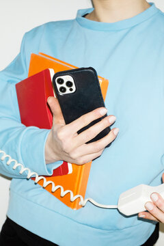 Person answering speaking to landline wire phone in work office 