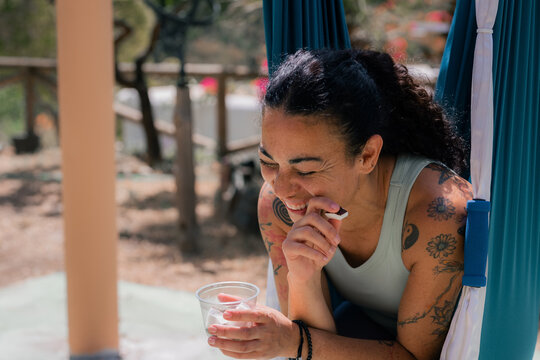 Woman eating fresh coconut and laughing 