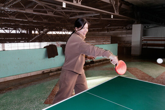 A woman hits a ball.