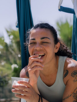 Woman eating fresh coconut in park 