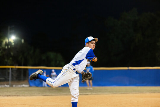 Baseball Player Pitching at Night Game